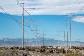 high voltage power lines in nevada with mountains in distance